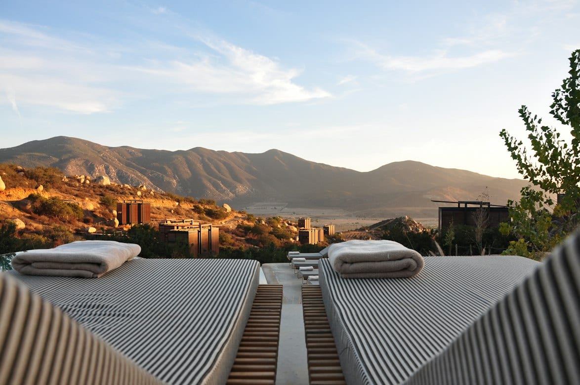 Relaxing loungers on a sunlit terrace overlooking the mountains